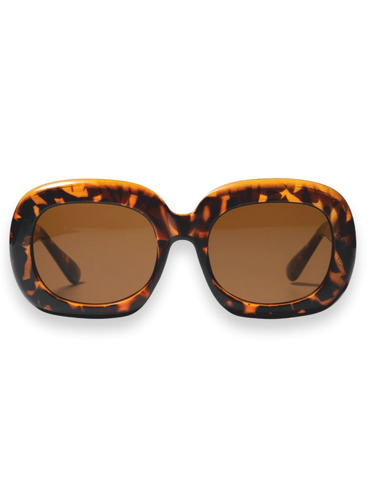 Oversized square sunglasses with a bold tortoiseshell patterned frame and warm brown lenses, shown against a plain white background.