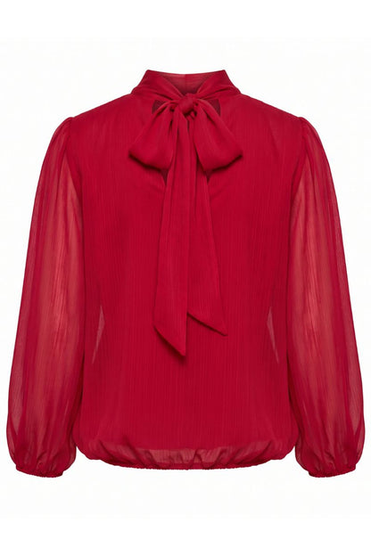 A vibrant red long-sleeve blouse made of pleated, semi-sheer chiffon-like fabric, featuring a high collar with a large bow at the neck and gathered sleeves.