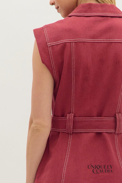 Red sleeveless jacket with a belt on a plain background