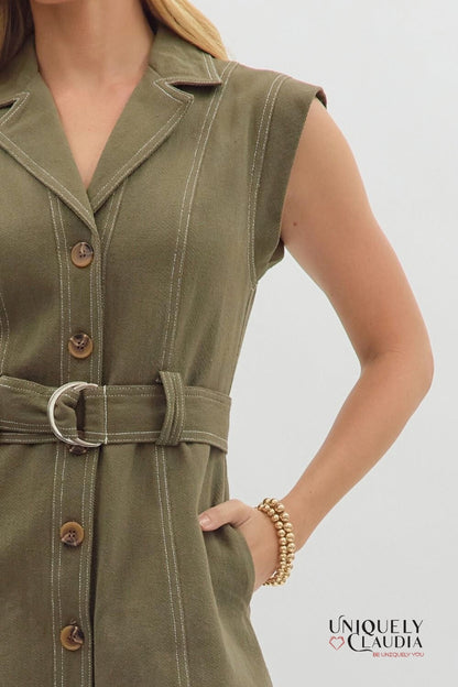 Green dress with buttons and a belt worn by a person on a light gray background, with 'Uniquely Claudia' branding.