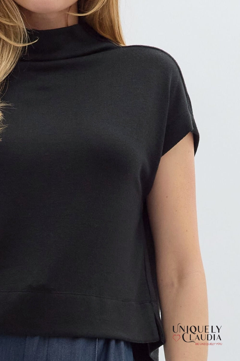 Black sleeveless top worn by a person on a white background, with 'Uniquely Claudia' branding.