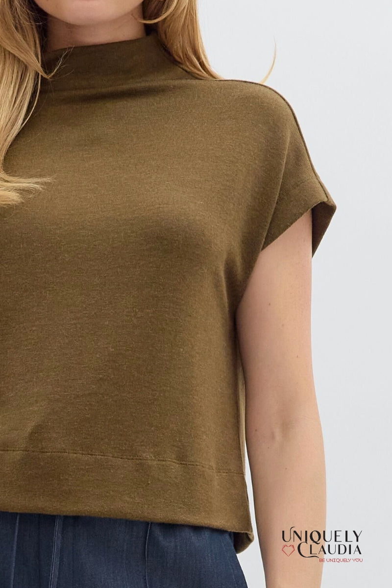 Brown sleeveless top worn by a person on a white background, with 'Uniquely Claudia' branding.