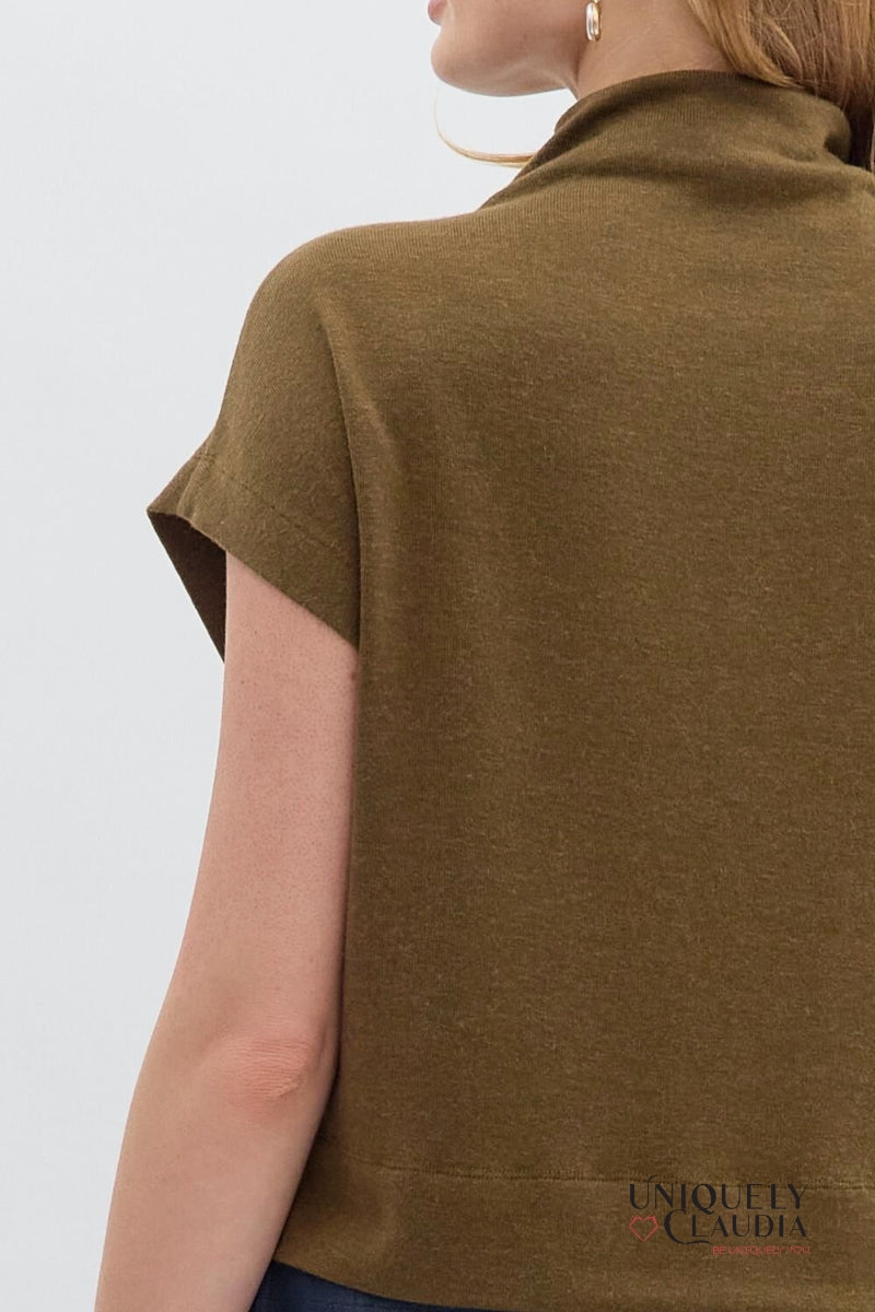 Brown top worn by a person on a light gray background