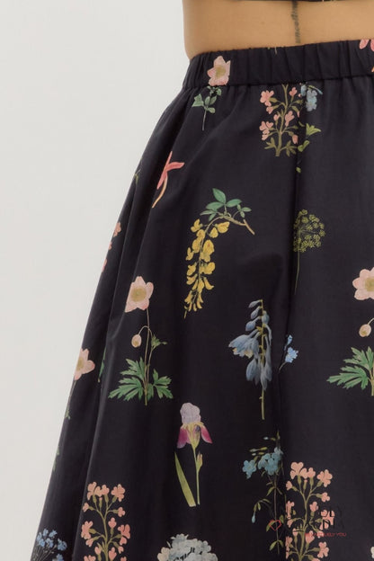 Black skirt with colorful floral pattern on a white background