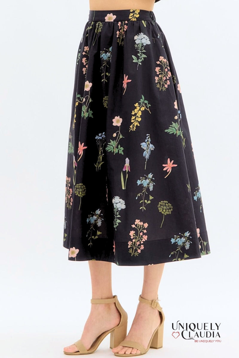 Floral patterned skirt on a white background with 'Uniquely Claudia' branding.