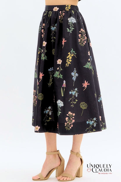 Floral patterned skirt on a white background with 'Uniquely Claudia' branding.