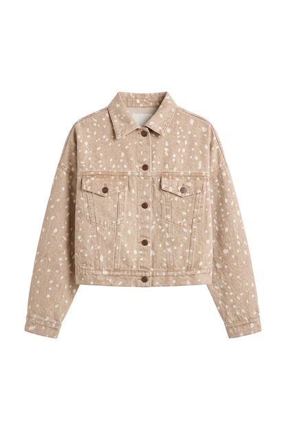 A cropped denim jacket in a light beige/tan color with a white speckled pattern, featuring a button-up front, two chest pockets, and a classic collar.