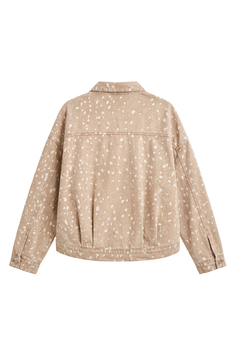 A beige cropped denim jacket with a white speckled print, shown from the back on a solid white background.
