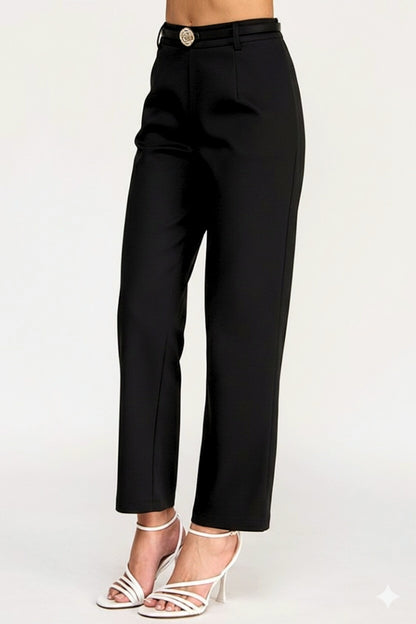 Black pants worn by a person on a white background