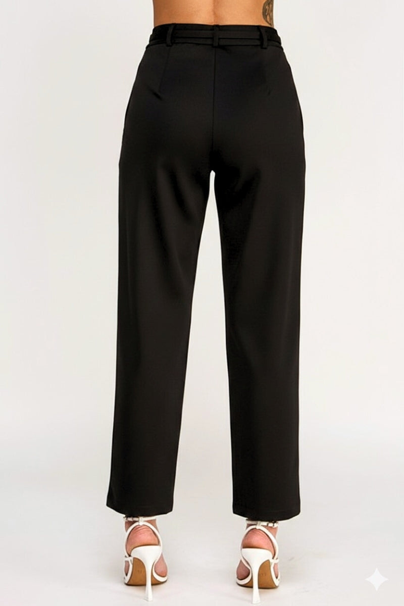 Black pants worn by a person on a white background