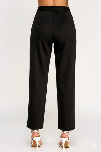 Black pants worn by a person on a white background