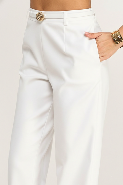 White pants with a gold button on a white background