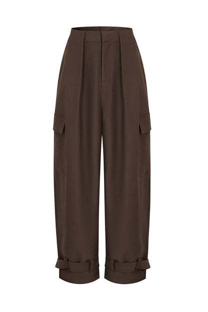 A pair of dark brown wide-leg cargo pants with pleated front details, side flap pockets, and rolled cuffs, shown against a plain white background.