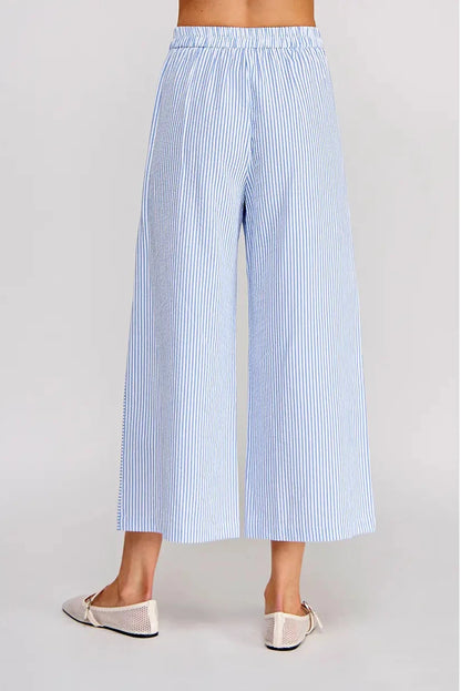 Light blue and white striped wide-leg pants on a plain background