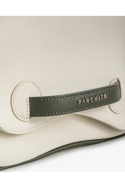 Close-up of a beige Parchita Brand handbag with a green leather tag