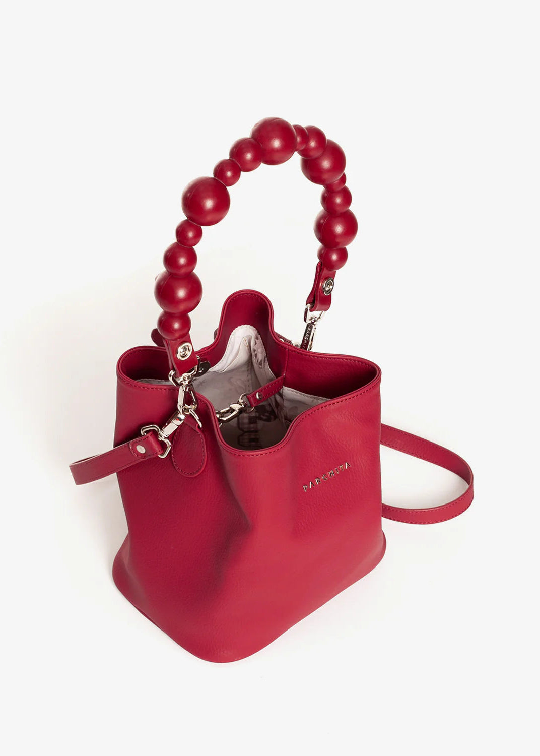 Red handbag with beaded handle on a white background