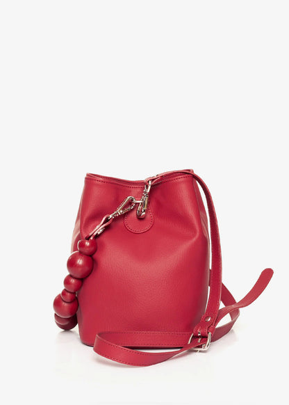 Red handbag with spherical handles on a white background