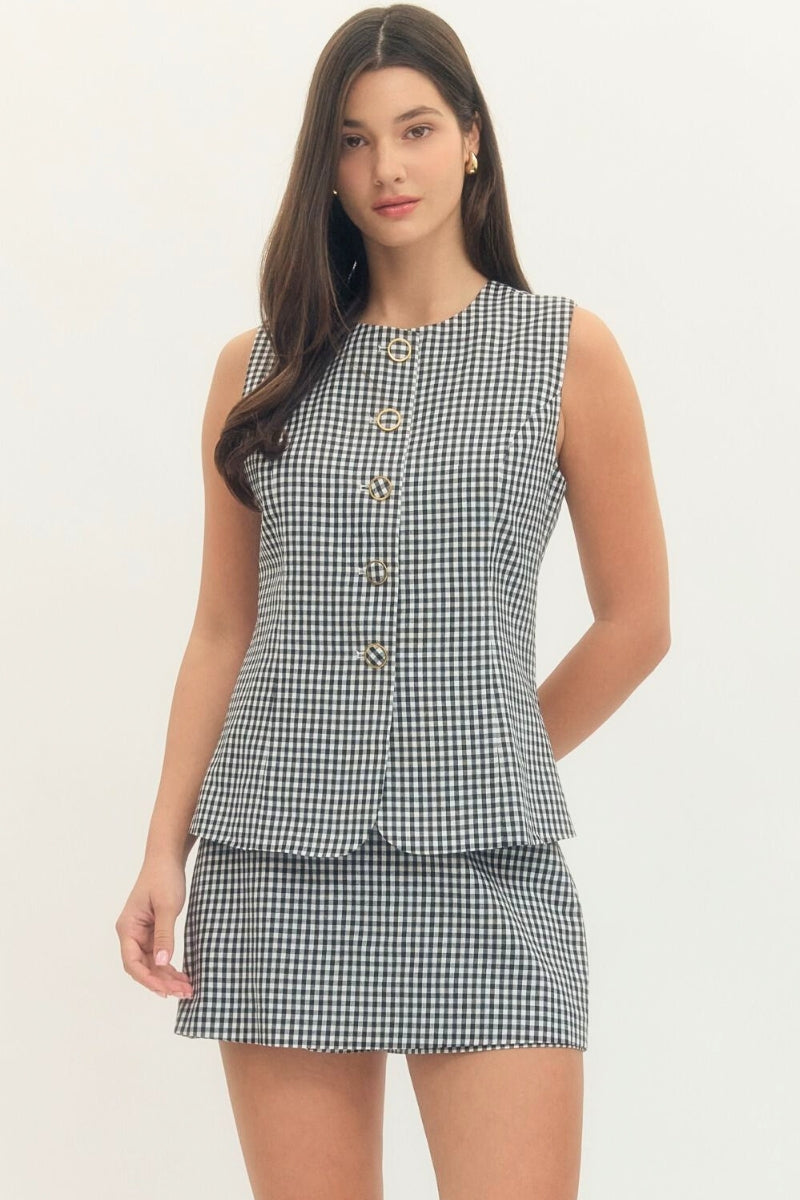 Woman wearing a checkered dress on a white background