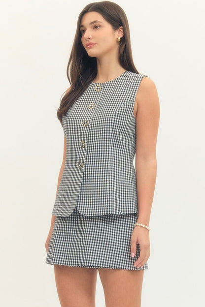 Woman wearing a checkered dress on a white background