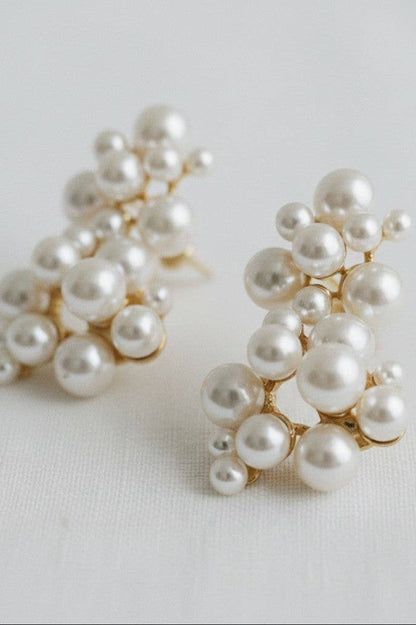 Pair of pearl earrings on a light gray background