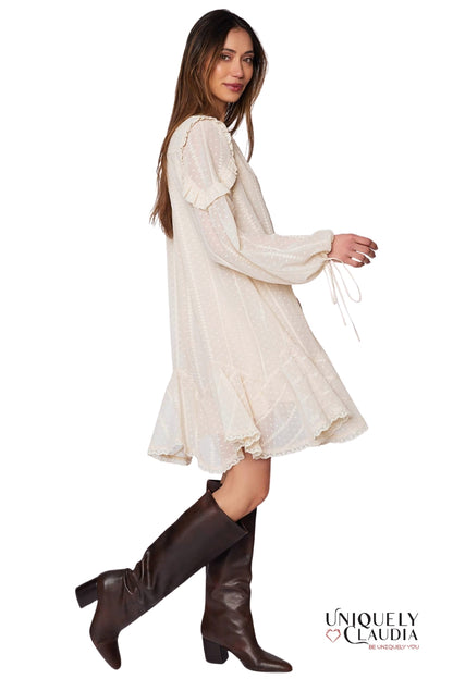Woman wearing a white dress and brown knee-high boots on a white background