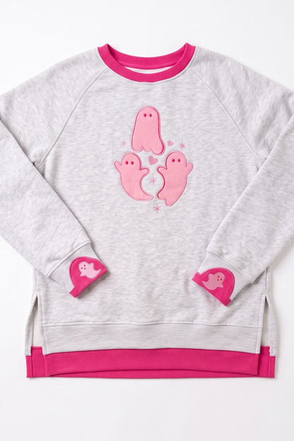 A light heather gray sweatshirt with vibrant pink accents, featuring three pink ghost appliqués on the chest and matching pink heart-shaped appliqués on the cuffs, displayed flat against a white background.