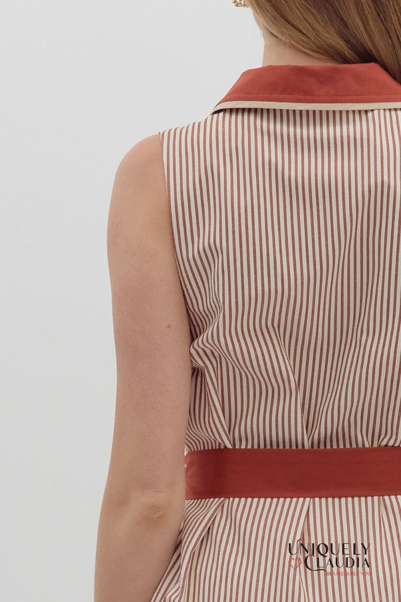 Striped dress with a red belt and collar on a plain background