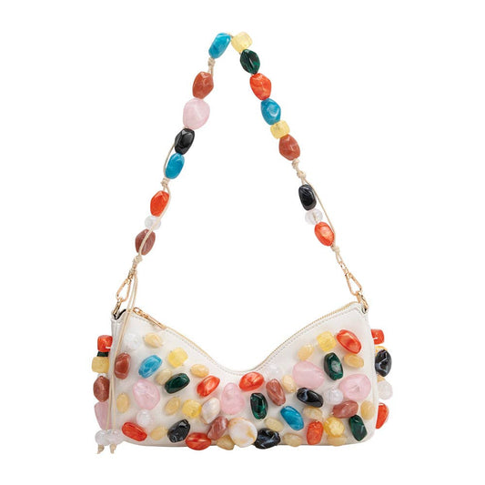 Colorful stone-themed handbag with a beaded handle on a white background