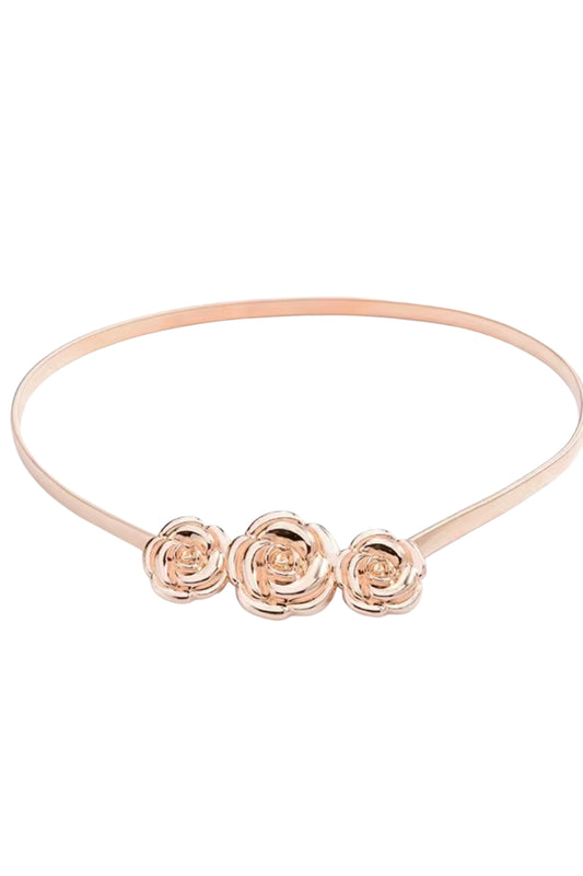 Rose gold headband with three floral designs on a white background