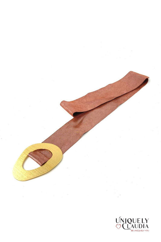 Brown belt with a gold buckle on a white background, branded 'Uniquely Claudia'.