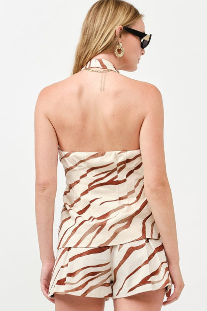 Woman wearing a zebra print romper on a white background