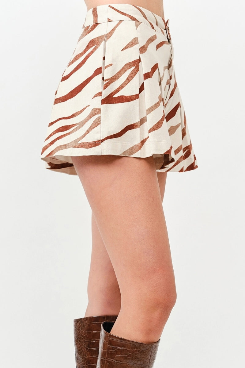 Skirt with brown and white pattern worn by a person on a white background