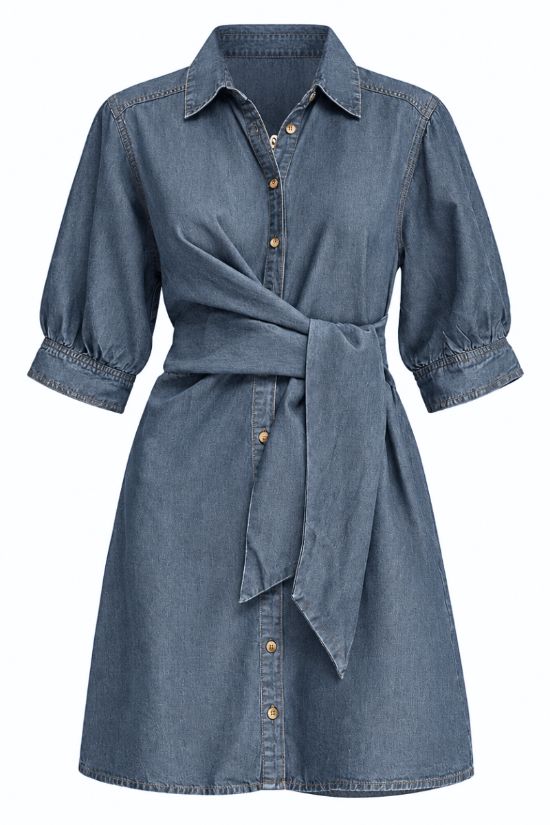 A blue denim shirt dress with three-quarter sleeves, a pointed collar, and a self-tie belt at the waist, shown against a plain white background.
