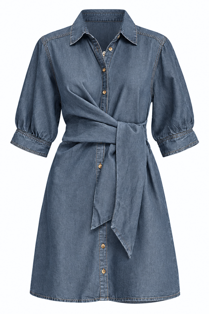 A blue denim shirt dress with three-quarter sleeves, a pointed collar, and a self-tie belt at the waist, shown against a plain white background.