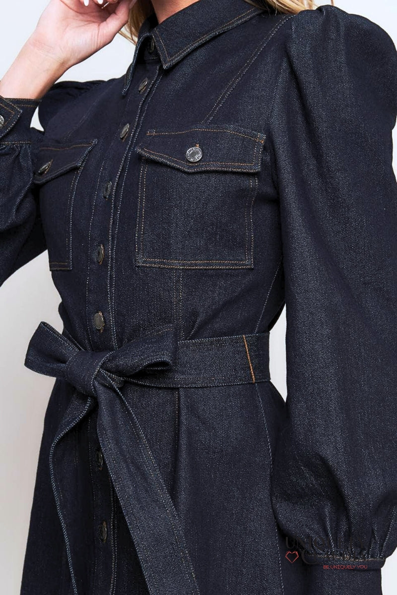 Dark denim dress with a belt on a plain background