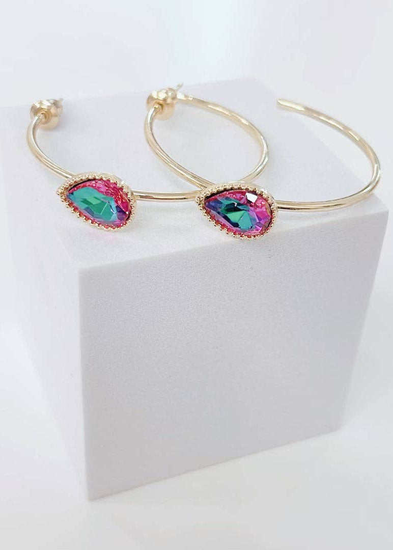 Gold hoop earrings with colorful gemstones on a white background