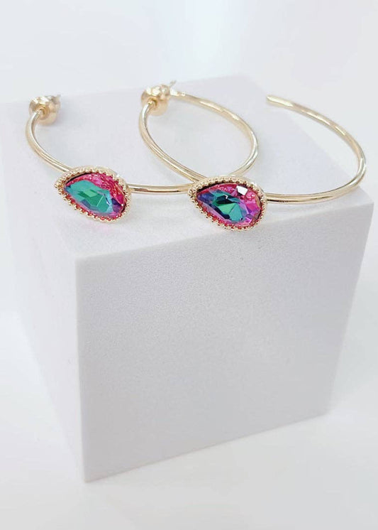 Gold hoop earrings with colorful gemstones on a white background