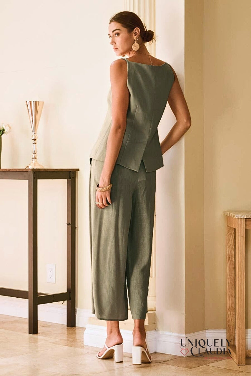 Woman wearing a green pant outfit standing 