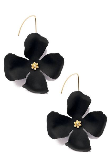 Black flower-shaped earrings with gold centers on a white background