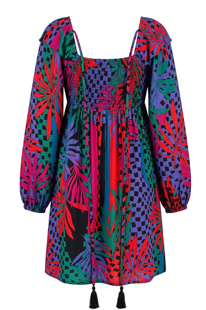 A vibrant, multicolor mini dress with a bold tropical leaf print, puff sleeves, a smocked bodice, and black tassel ties at the hem, shown against a plain white background.