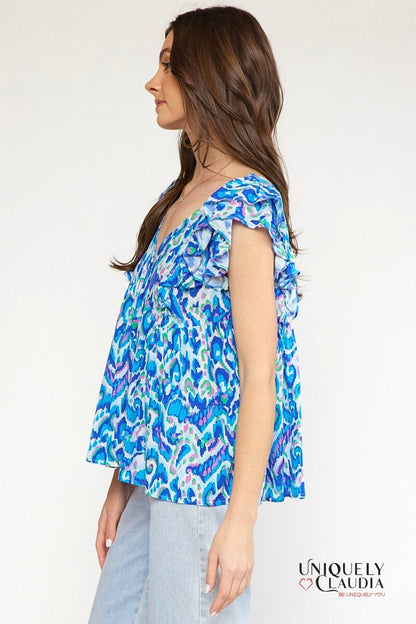 woman wearing flutter sleeves blue top